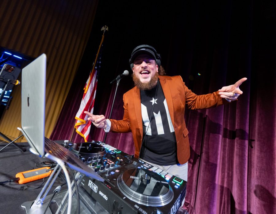 DJ on stage smiling at camera