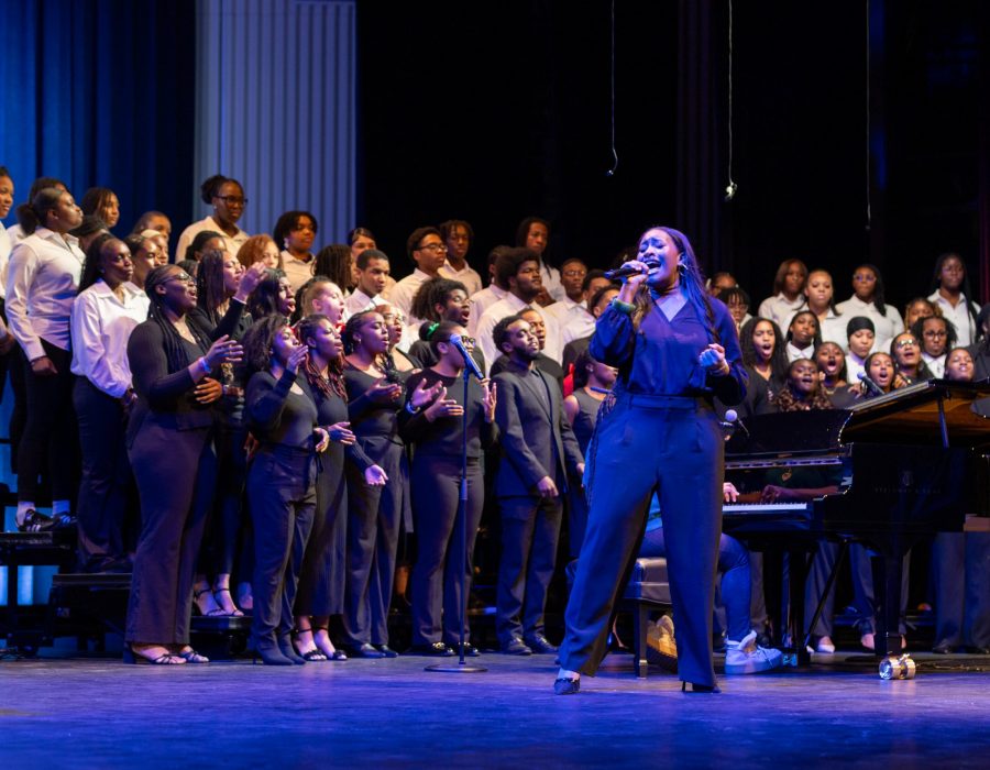 Singer on stage with choir in the background