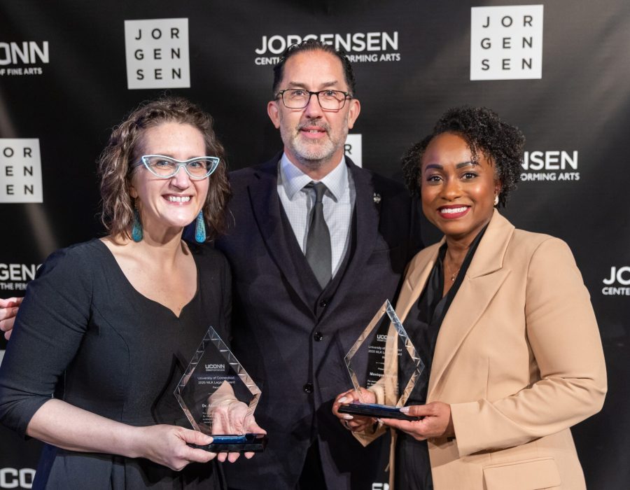 Faculty and staff honorees smiling while holding awards