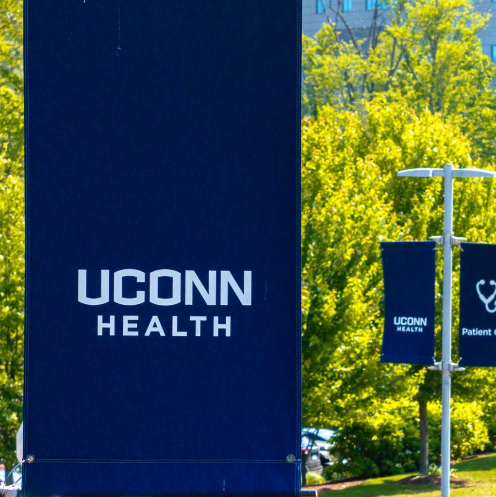 Blue "UConn Health" sign on lamppost