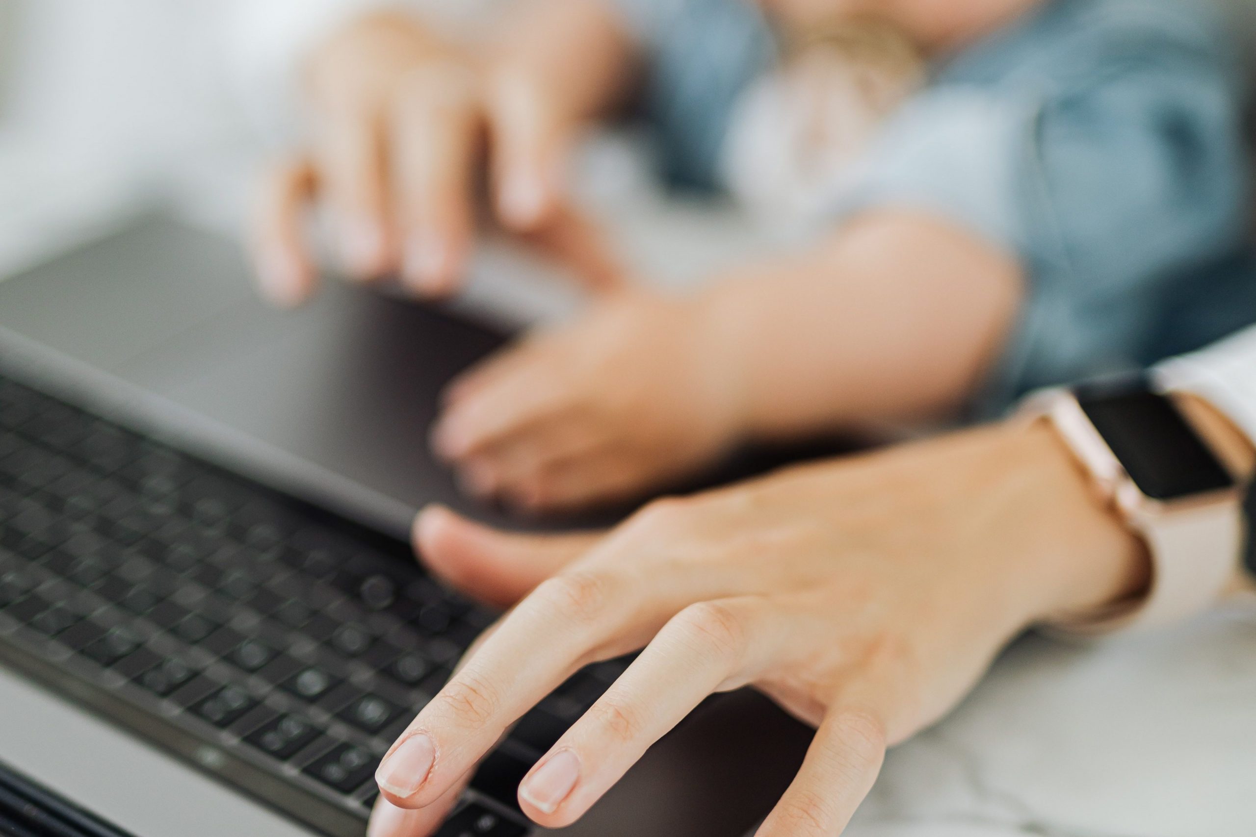 Person using laptop with child on their lap